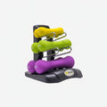 Set of colorful dumbbells on a black stand against a white background