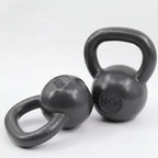 iron kettlebells on a light gray 