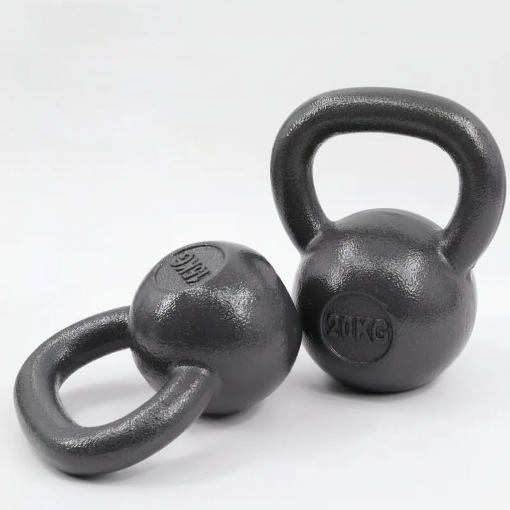 iron kettlebells on a light gray 
