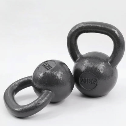 iron kettlebells on a light gray 