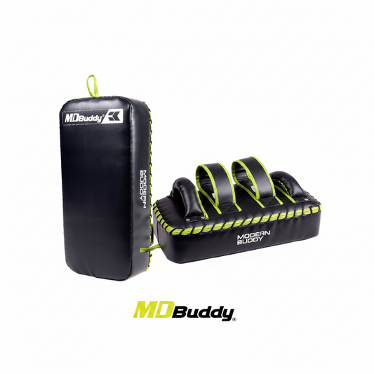 The MD Buddy Kick Shield is a lightweight yet sturdy training tool designed for martial arts like MMA, Muay Thai, Krav Maga, and kickboxing. Its 40 × 20 × 10 cm strike pad provides a wide, stable target area for practicing kicks with comfort and precision. Strategically placed handles and adjustable straps ensure a secure, ergonomic fit on the forearms, allowing trainers and partners to hold it easily during intense sessions. Made from durable PVC and EPE materials, this kick shield withstands repeated stri