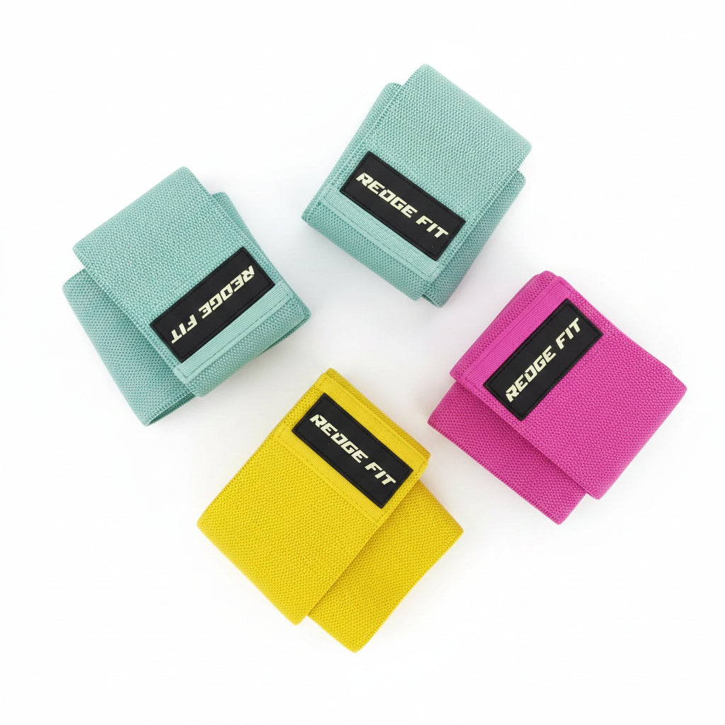 Three textured fabric wrist wraps in mint green, bright pink, and yellow, each with a black label reading 'REGE FIT' in gold text, arranged on a dark gray background. A brand logo 'HYOYGA' appears in the top-left corner, and 'UPC:00524' appears in the top-right.