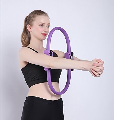 Woman using a purple exercise ring against a white background