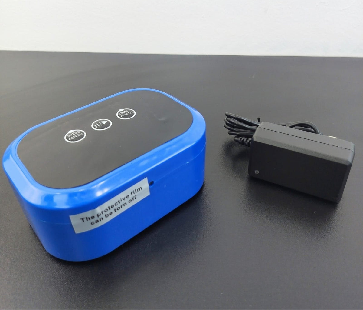 A blue and black UV germicide lamp shown next to its black power adapter on a dark gray surface, with a white background. The brand logo 'H&R MEDICINES' is visible in the top left corner, and a UPC code is in the top right.