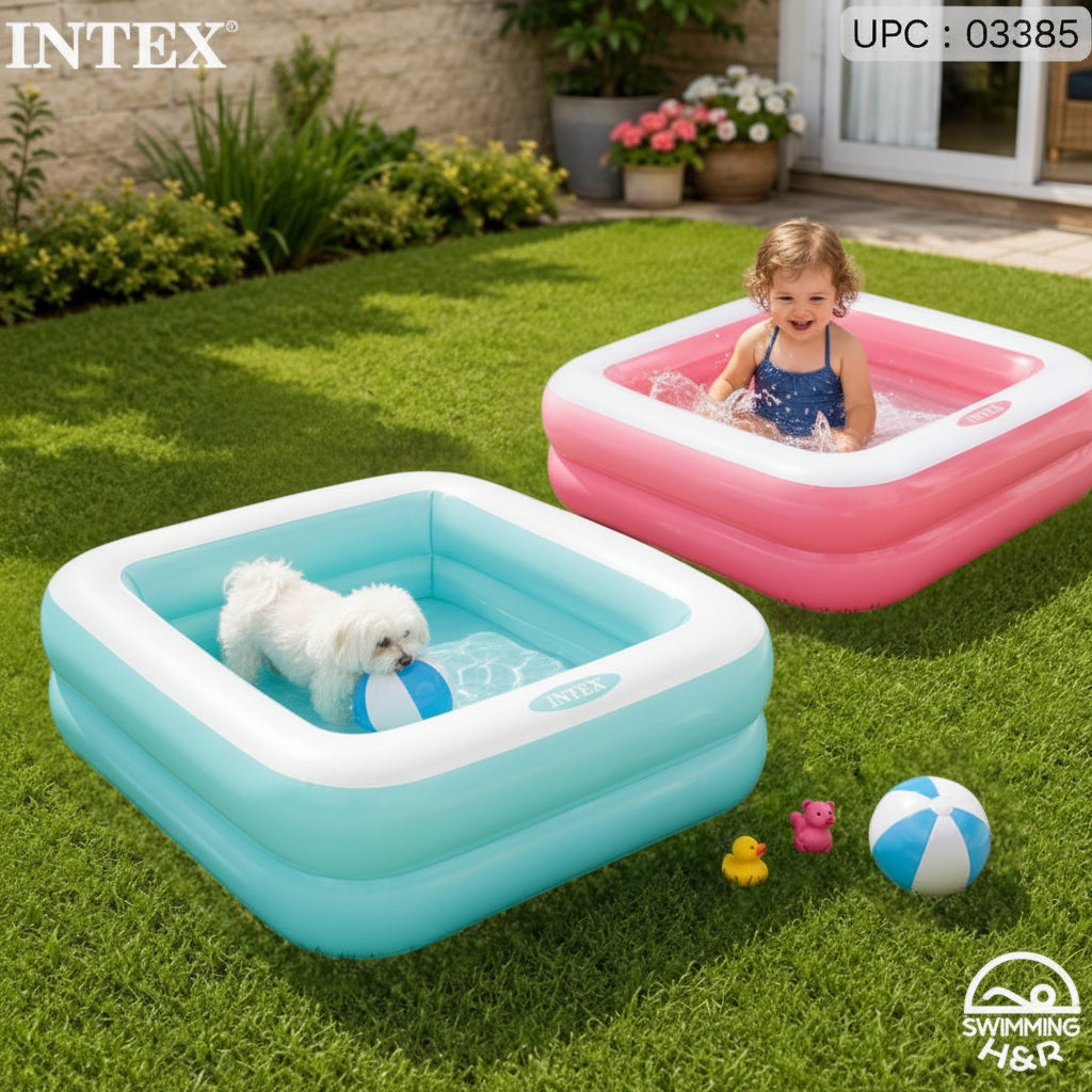 A young child sitting in a light blue and white inflatable swimming pool on a green lawn, with a second pink and white inflatable pool behind it. The Intex brand logo is visible in the top left corner.