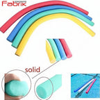 Colorful foam noodles with a hand holding one and a pool setting, branded 'Fabrik'.