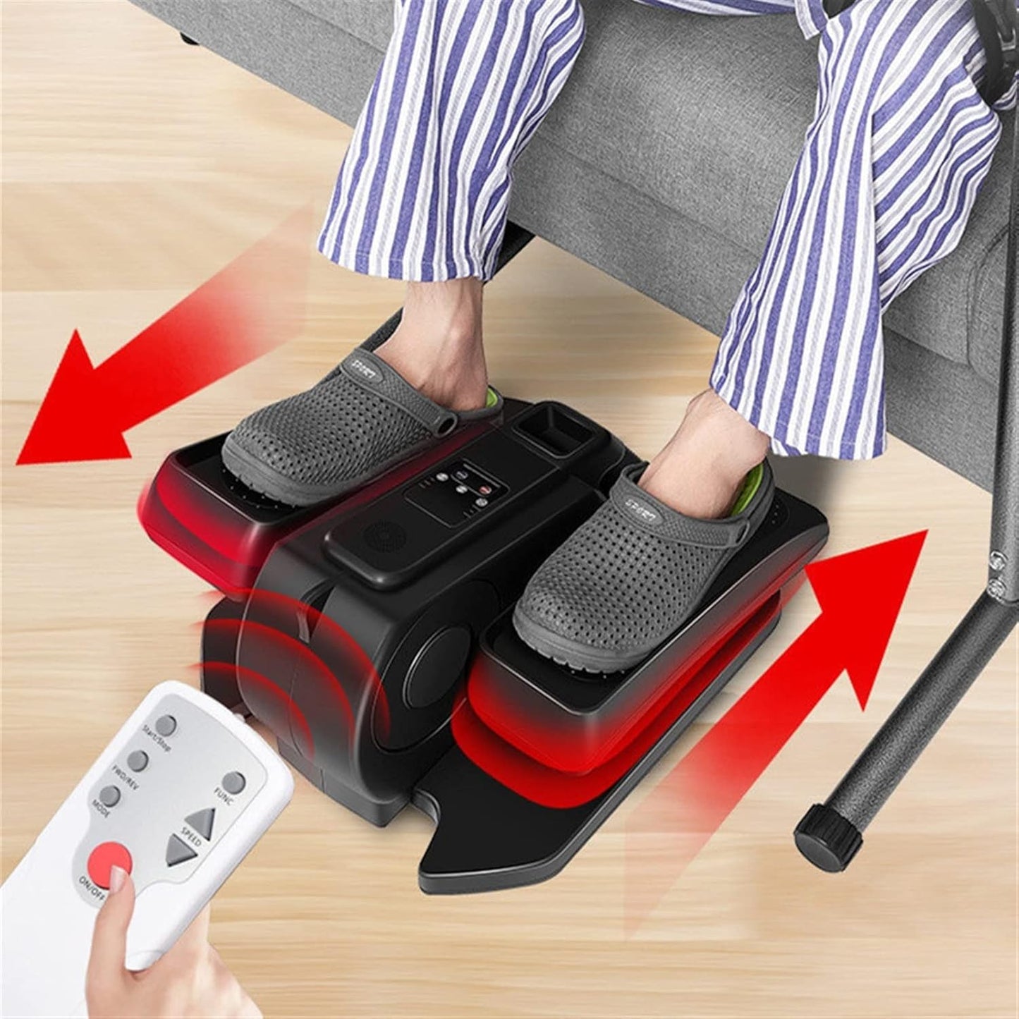 Person using a foot massager with remote control on a wooden floor.