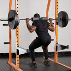 Person performing a barbell squat in a gym setting