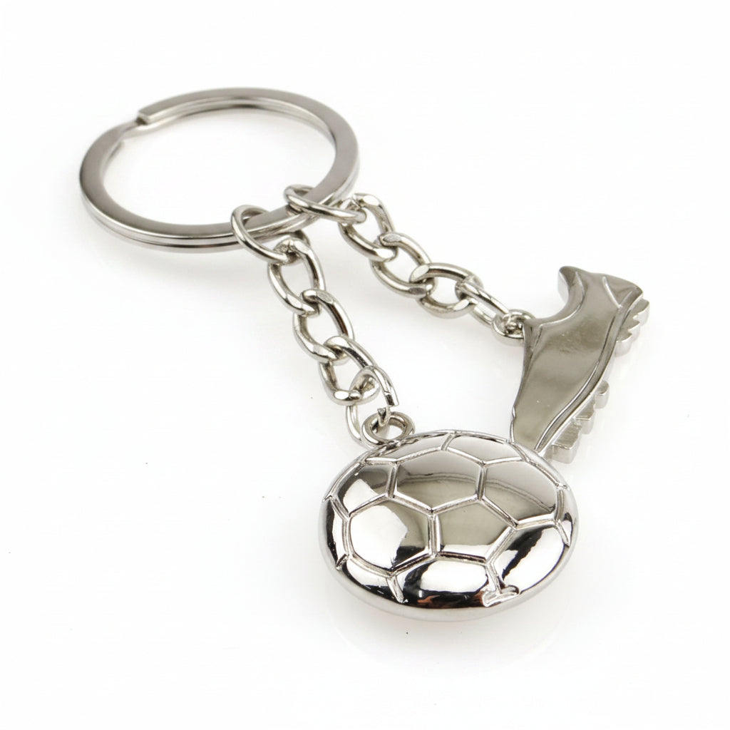A silver metal keychain featuring a soccer ball charm, a cleat charm, and a split key ring,