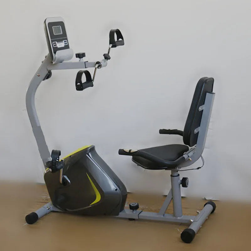 Recumbent exercise bike on a wooden floor with a white wall background