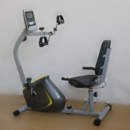 Recumbent exercise bike on a wooden floor with a white wall background