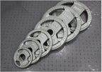Set of weight plates with labeled weights on a textured surface