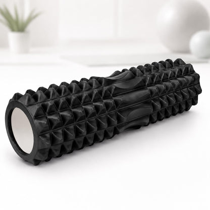A black textured foam roller with a ribbed and pyramid-patterned surface, 