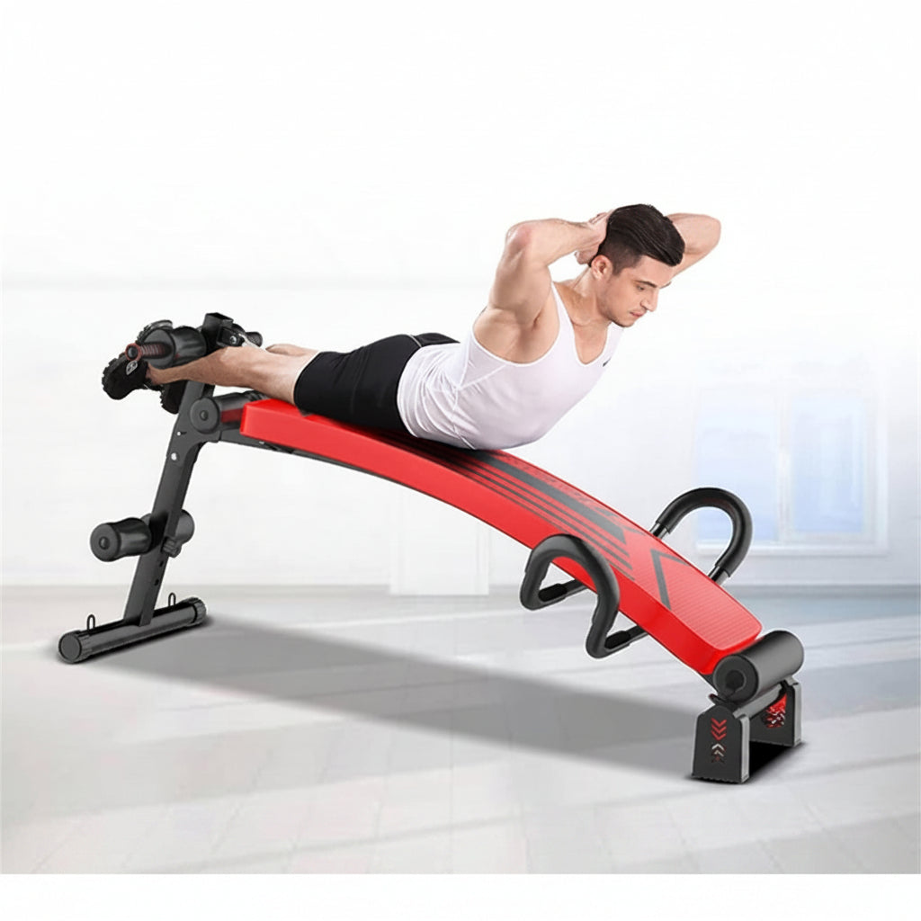 A man in a white tank top and black shorts is performing a abdominal exercise on a red and black 