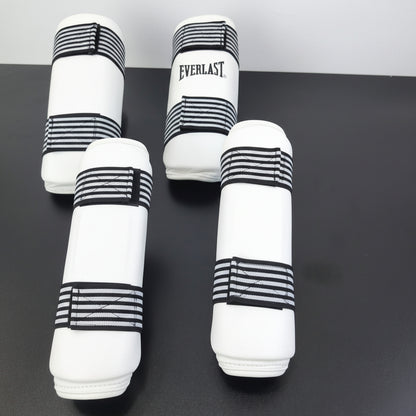 pairs of Everlast boxing shin guards displayed on a dark surface,