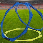 Blue and yellow plastic agility rings on a green soccer field with a blurred stadium background.