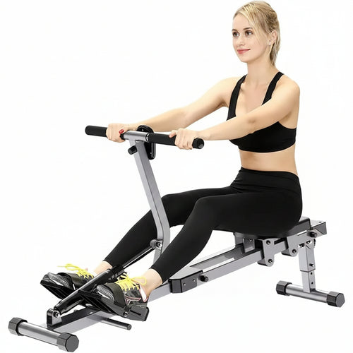 Woman using a rowing machine on a white background