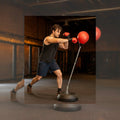  training with a punching bag in a gym setting