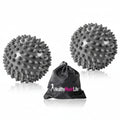 Two gray spiked massage balls with a black drawstring bag labeled 'Healthy Mode Life' on a white background.