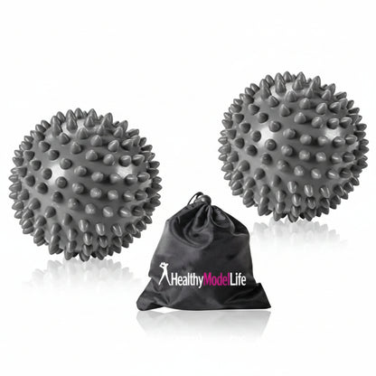 Two gray spiked massage balls with a black drawstring bag labeled 'Healthy Mode Life' on a white background.