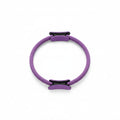 Purple Pilates ring with black clips on a white background