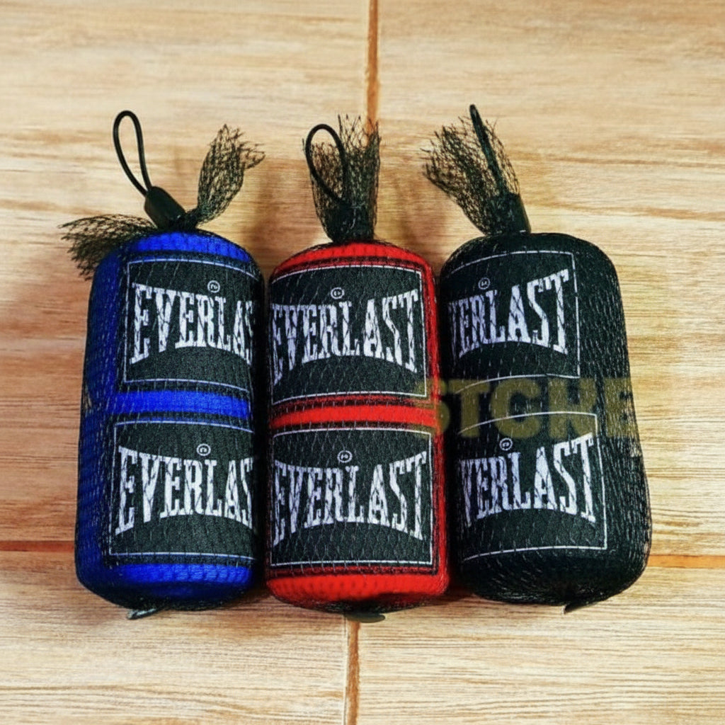 Three rolls of Everlast hand wraps on a wooden surface