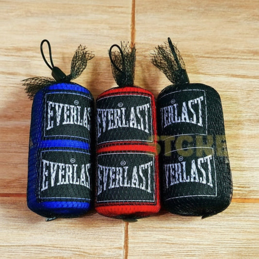 Three rolls of Everlast hand wraps on a wooden surface