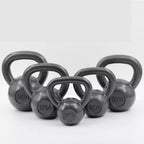Five cast iron kettlebells in different weights (5kg, 6kg, 12kg, 15kg, 20kg) arranged in a semi-circle on a light gray background.