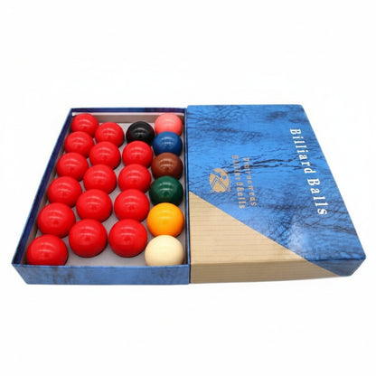 A boxed set of billiard balls shown open on a plain white background, with red, black, blue, green, yellow, orange, and white balls arranged in the tray and a blue wooden case beside it.