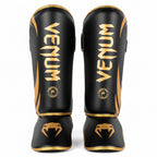 Black and gold Venum shin guards 