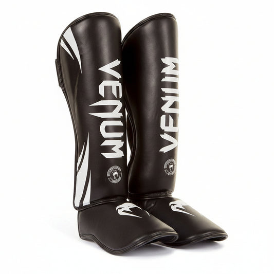 Pair of black Venum shin guards \brothersshop